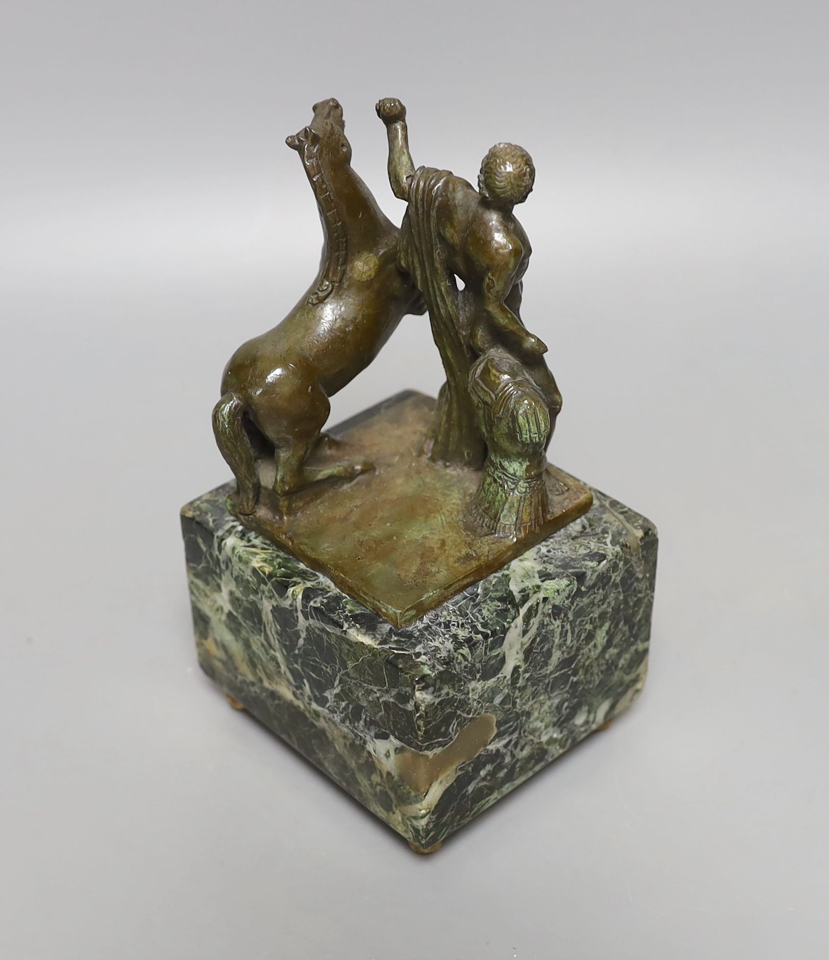 A Roman style bronze of a man and horse on a marble base 17cm